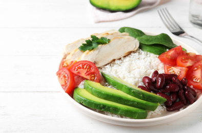 Photo of Delicious rice with beans and meat served on white wooden table, closeup