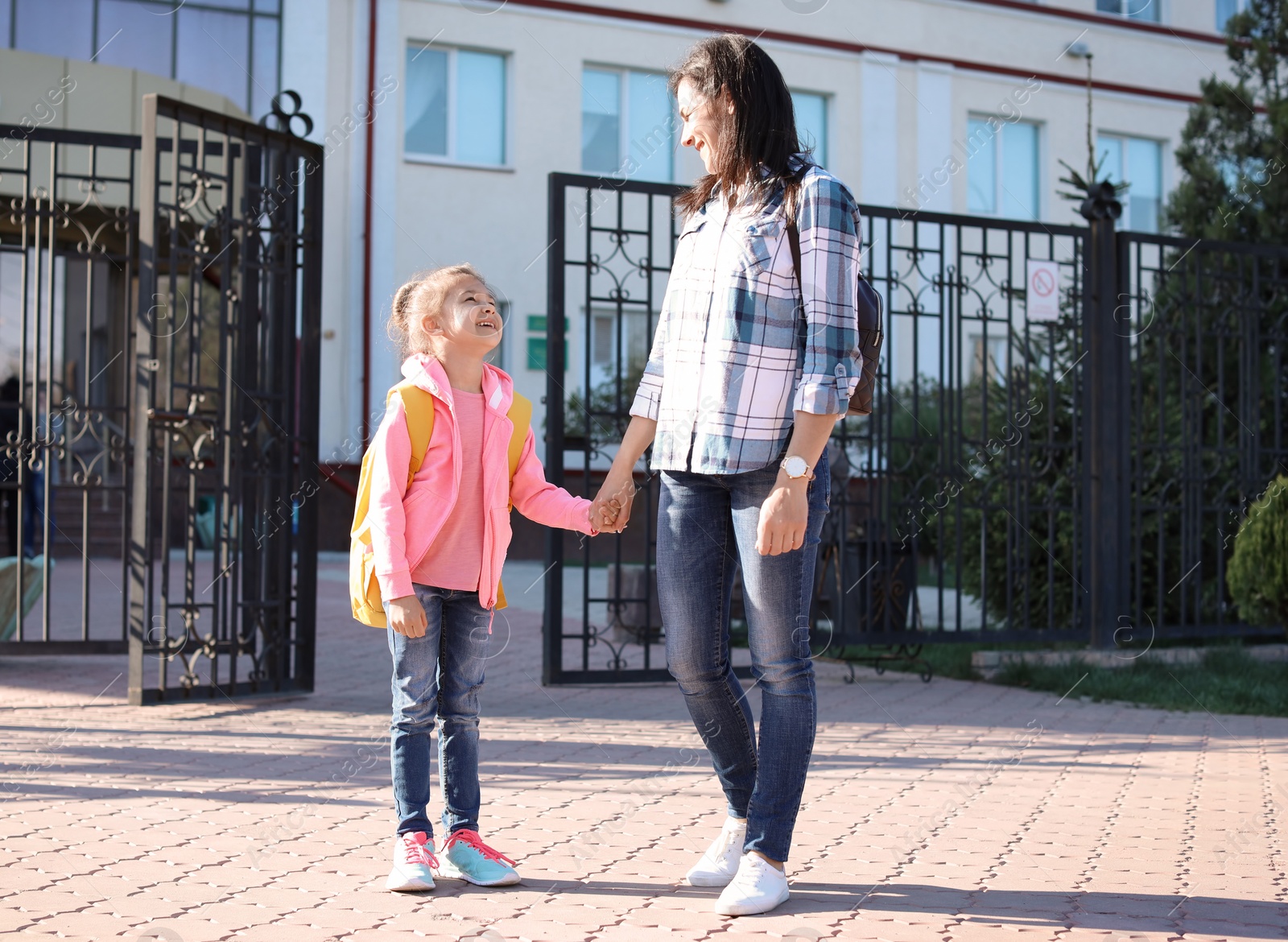 Photo of Young woman taking her little child to school