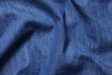 Photo of Texture of blue crumpled fabric as background, top view