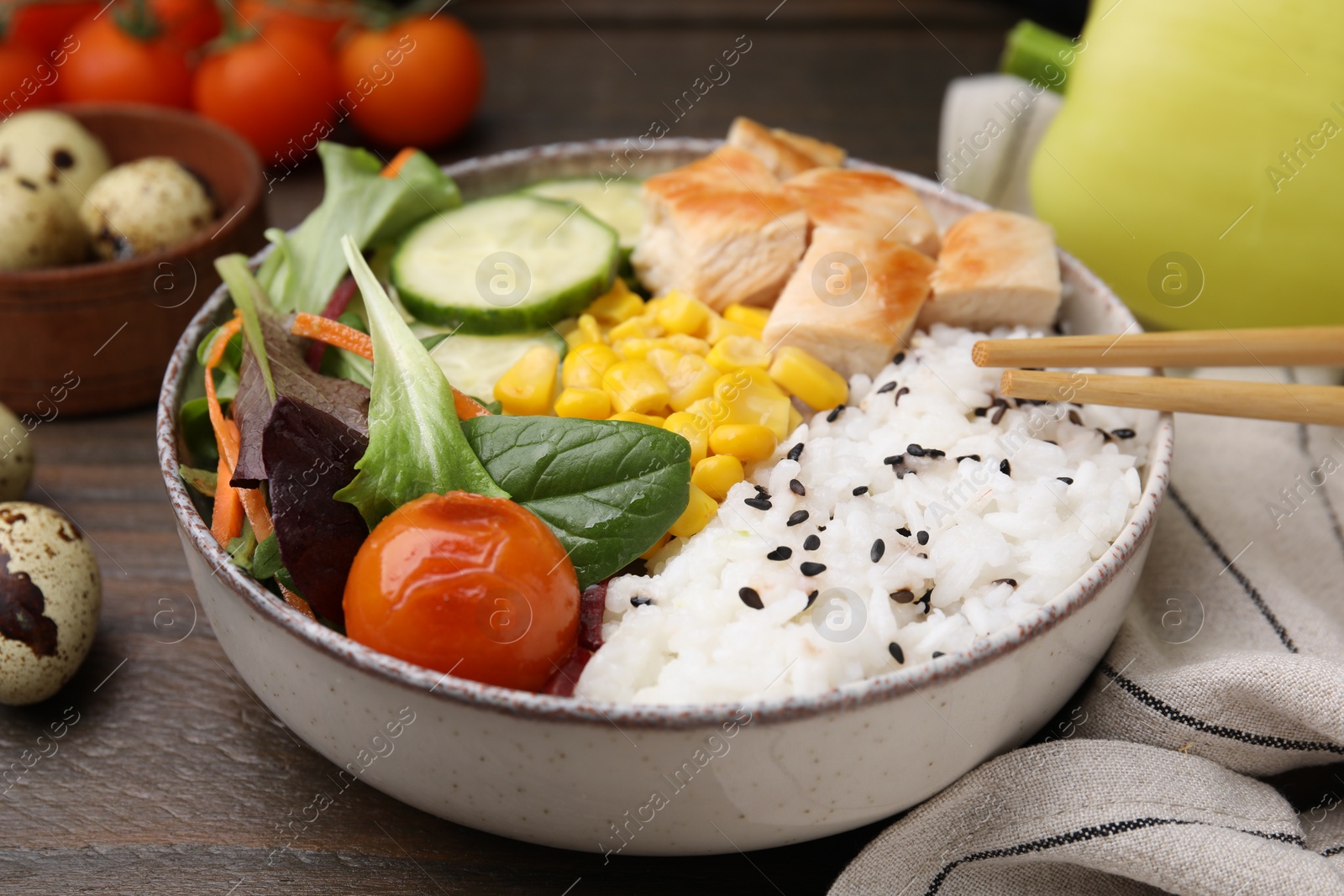 Photo of Delicious poke bowl with meat, rice, vegetables and greens on wooden table, closeup