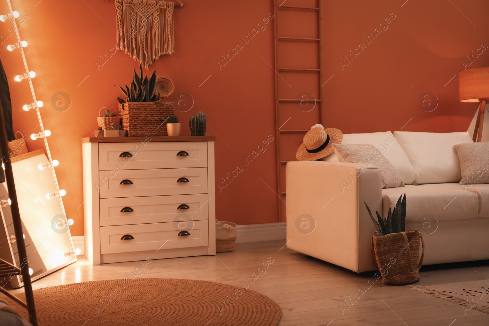 Photo of Large mirror with light bulbs and chest of drawers in stylish room interior