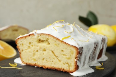 Photo of Tasty lemon cake with glaze on table, closeup