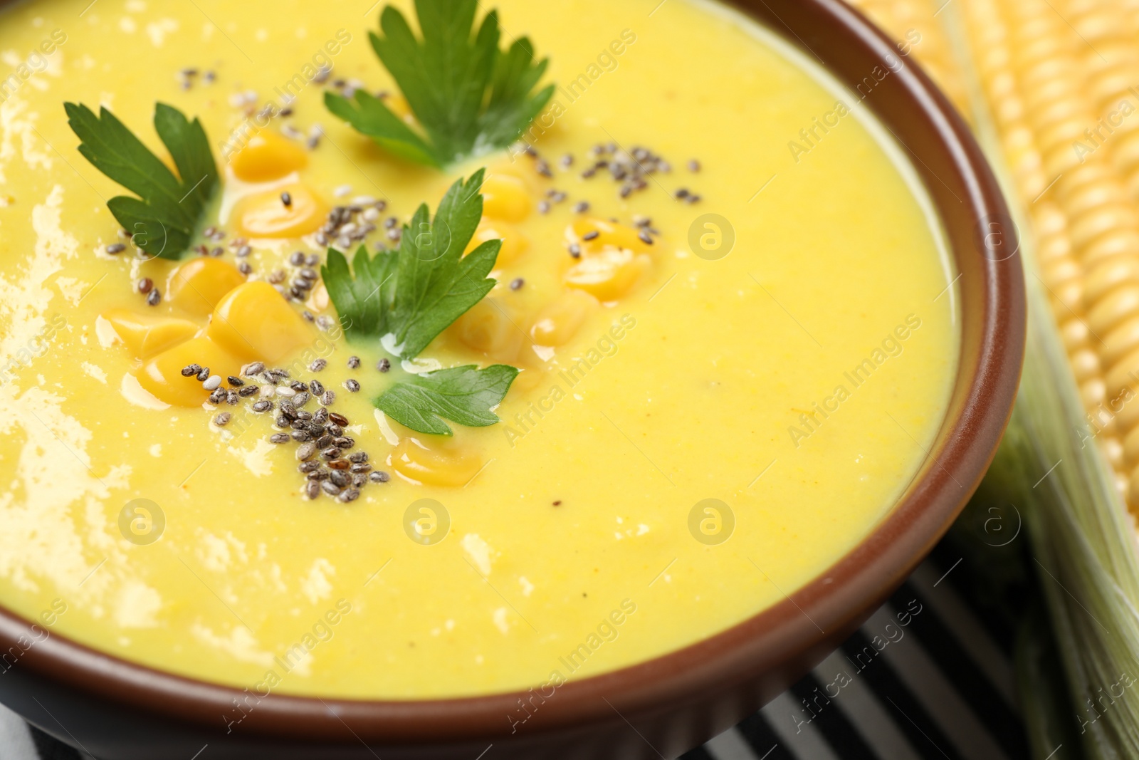 Photo of Delicious creamy corn soup on table, closeup