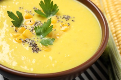 Delicious creamy corn soup on table, closeup