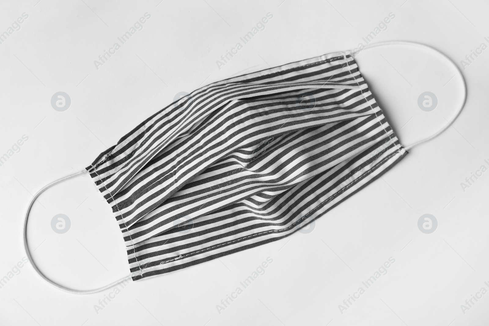 Photo of Homemade protective face mask on white background, top view