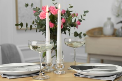 Romantic table setting with candles and flowers