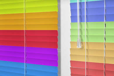 Image of Closed multicolor window blinds as background, closeup view