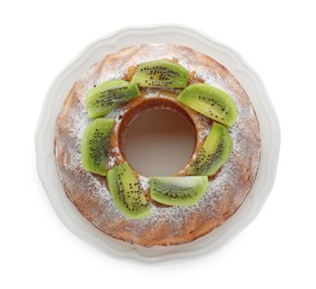 Homemade yogurt cake with kiwi and powdered sugar on white background, top view