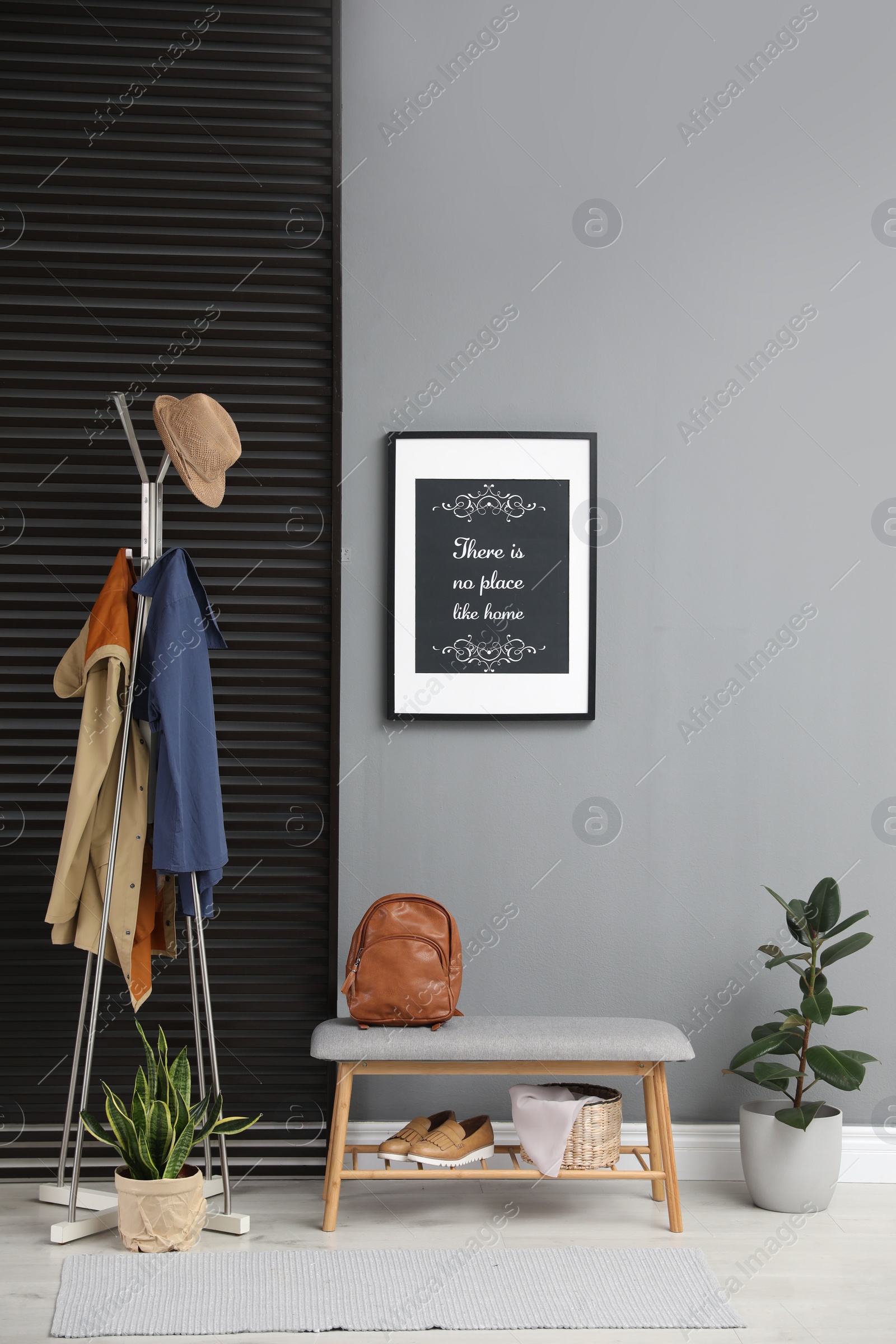 Photo of Hallway interior with stylish furniture, clothes and accessories