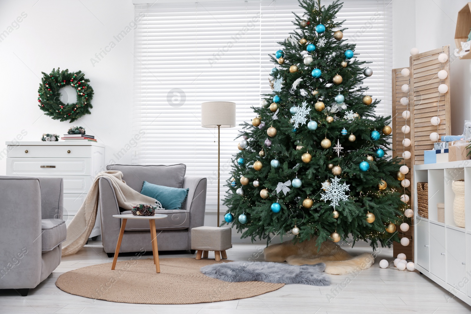 Photo of Christmas tree in room decorated for holiday. Festive interior design