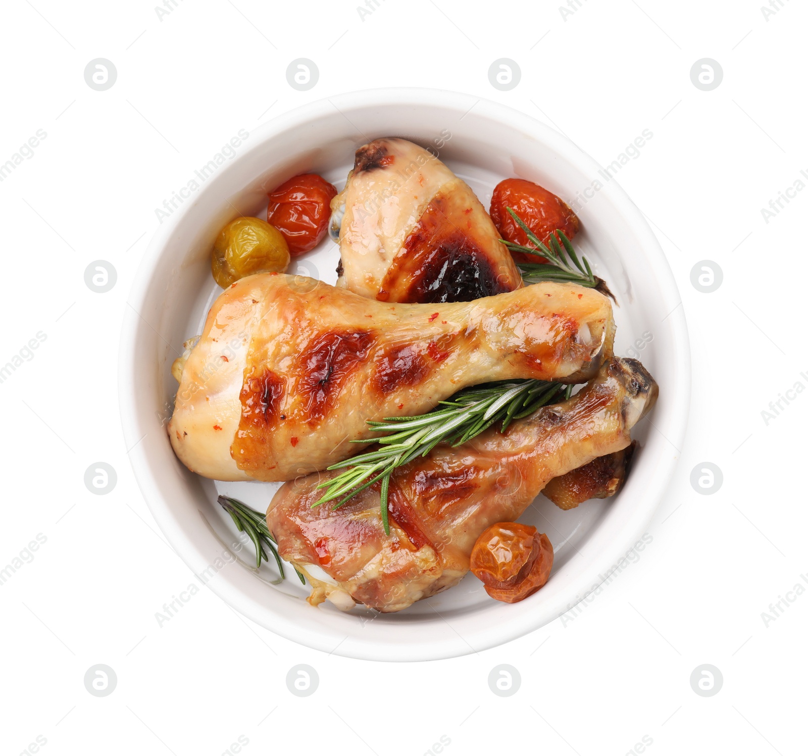 Photo of Delicious roasted chicken drumsticks with rosemary and tomatoes in bowl isolated on white, top view