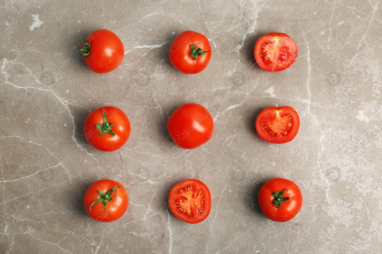 Photo of Flat lay composition with ripe tomatoes on grey background