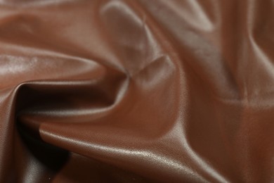 Brown natural leather as background, closeup view