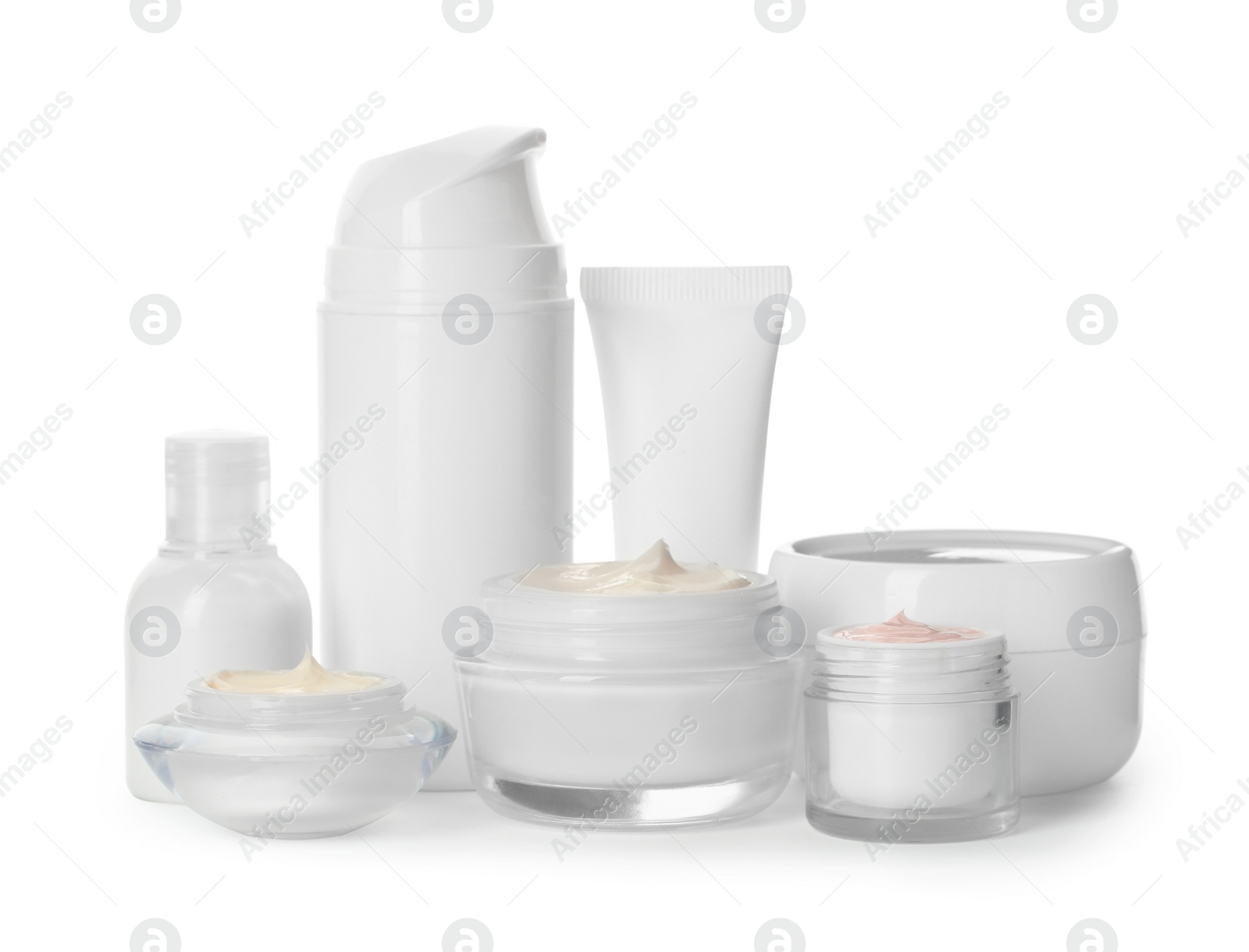 Photo of Different containers with hand cream and other cosmetic on white background