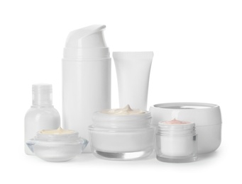 Photo of Different containers with hand cream and other cosmetic on white background