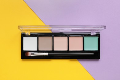 Contouring palette on color background, top view. Professional cosmetic product