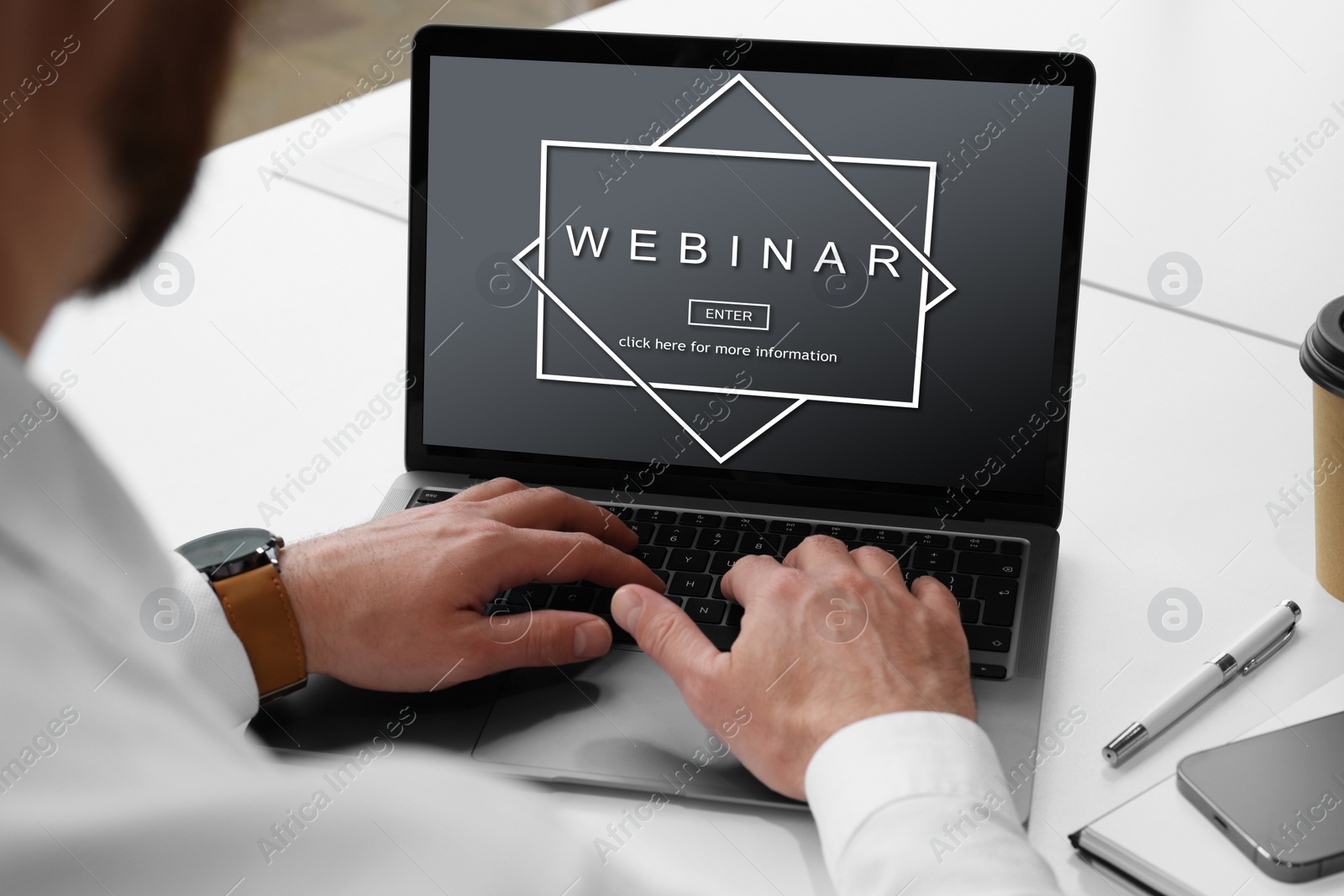 Image of Online webinar, web page on computer screen. Man using laptop at white table, closeup