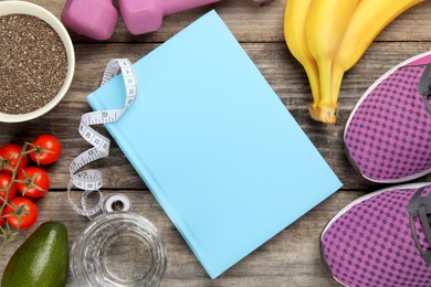 Photo of Weight loss concept. Flat lay composition with notebook, measuring tape and products on wooden table