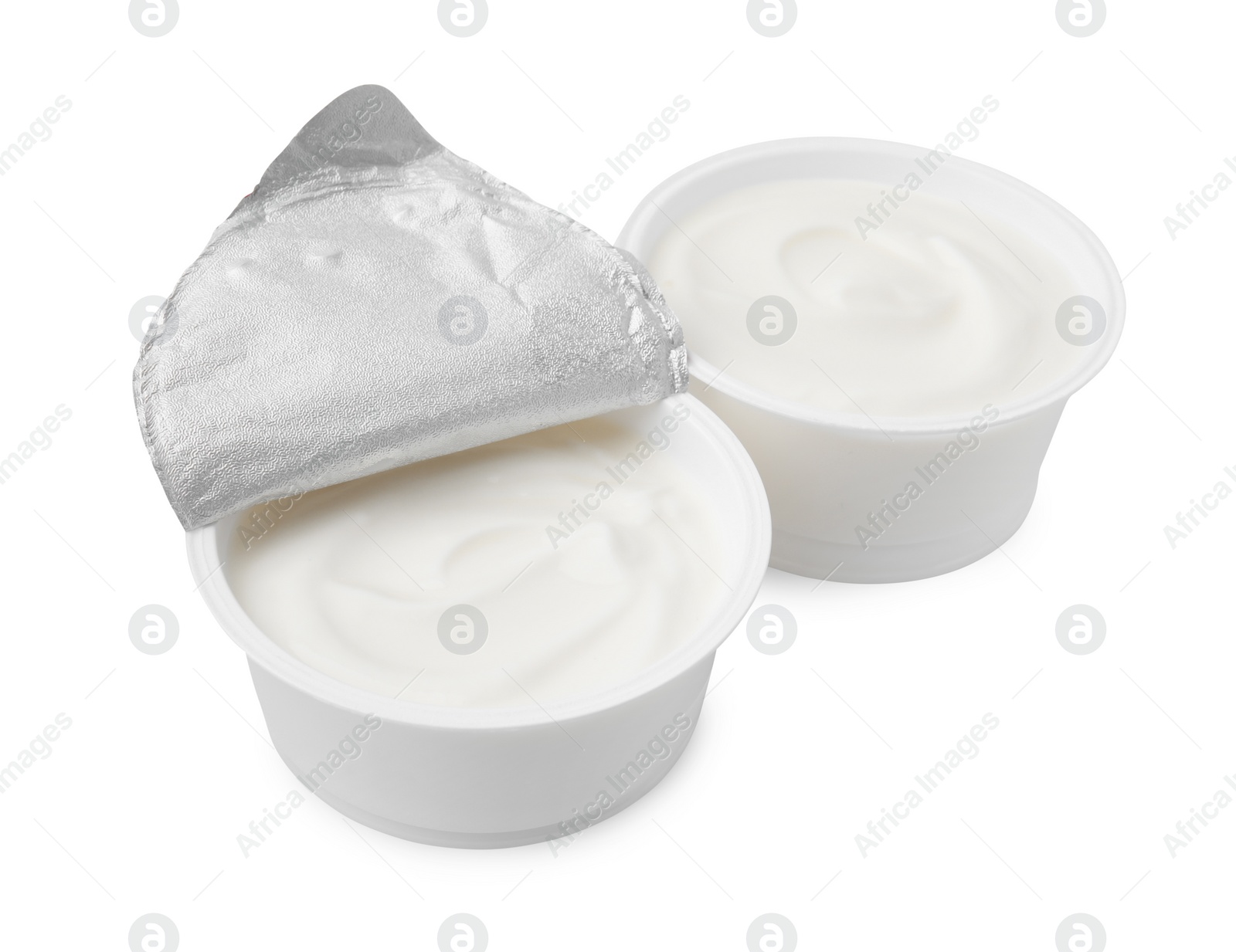 Photo of Delicious natural yogurt in plastic cups isolated on white