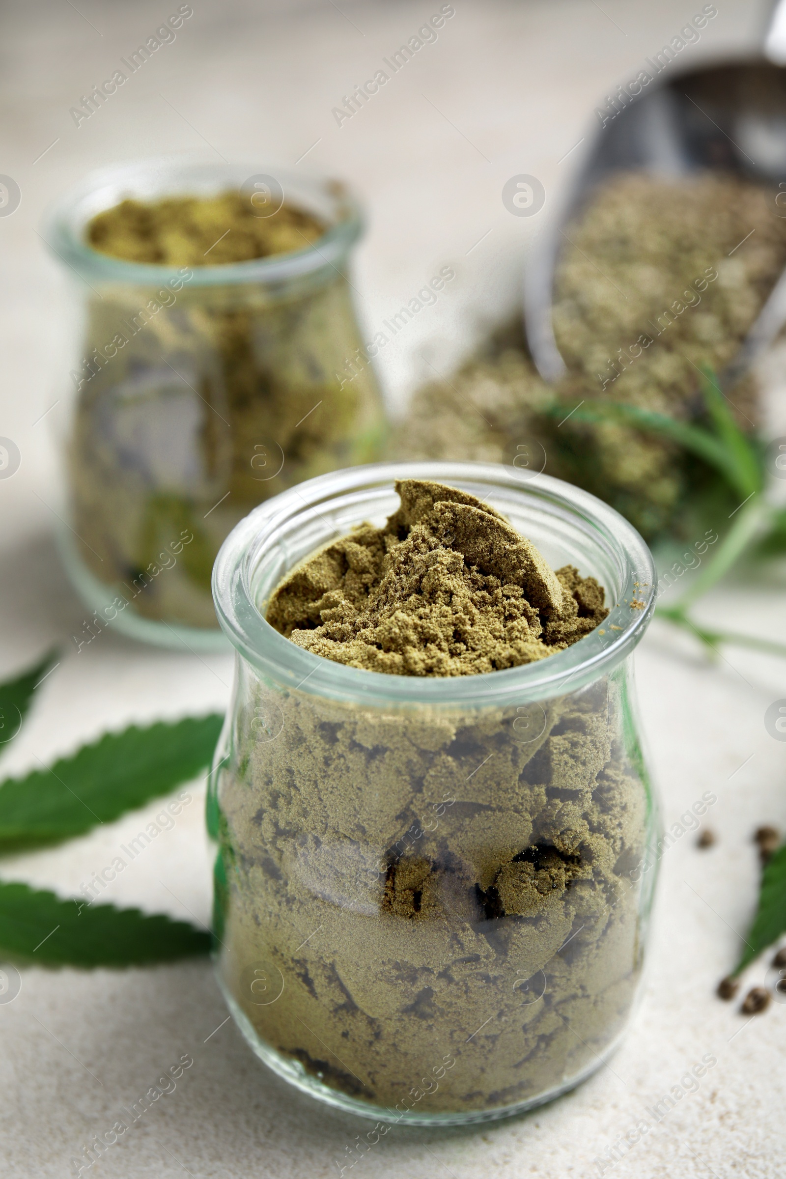 Photo of Hemp protein powder on light grey table, closeup