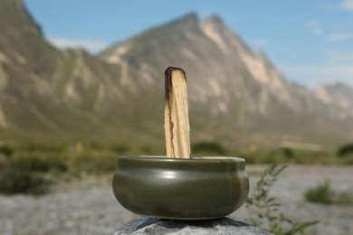 Photo of Burnt palo santo stick in high mountains
