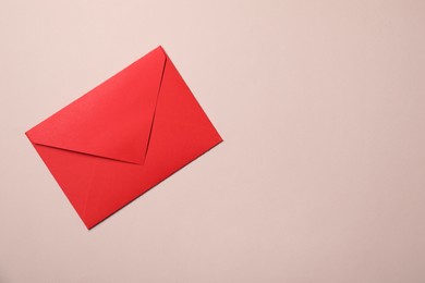 Letter envelope on beige background, top view. Space for text