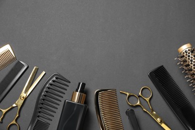 Photo of Hairdressing tools on dark table, flat lay. Space for text