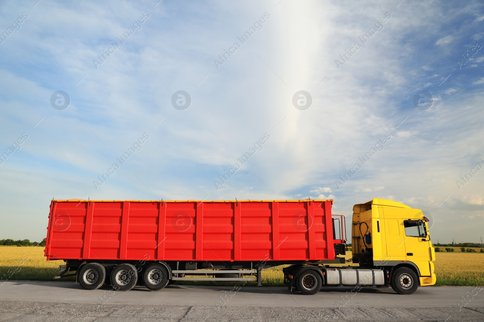 Photo of Modern bright truck parked on country road