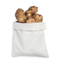 Bag and many Jerusalem artichokes isolated on white, top view