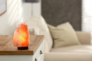 Photo of Himalayan salt lamp on table at home, space for text
