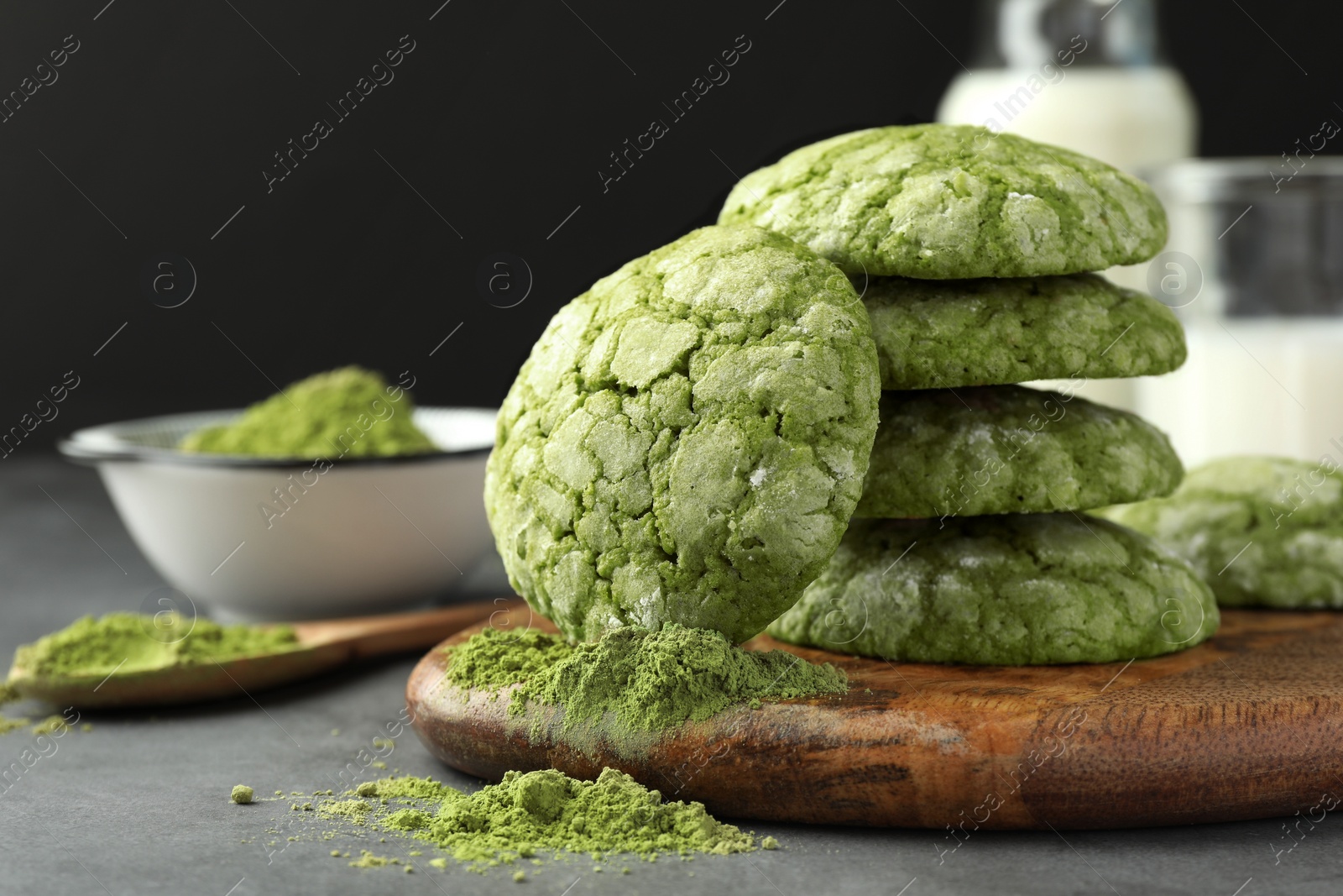 Photo of Tasty matcha cookies and powder on grey table, closeup. Space for text
