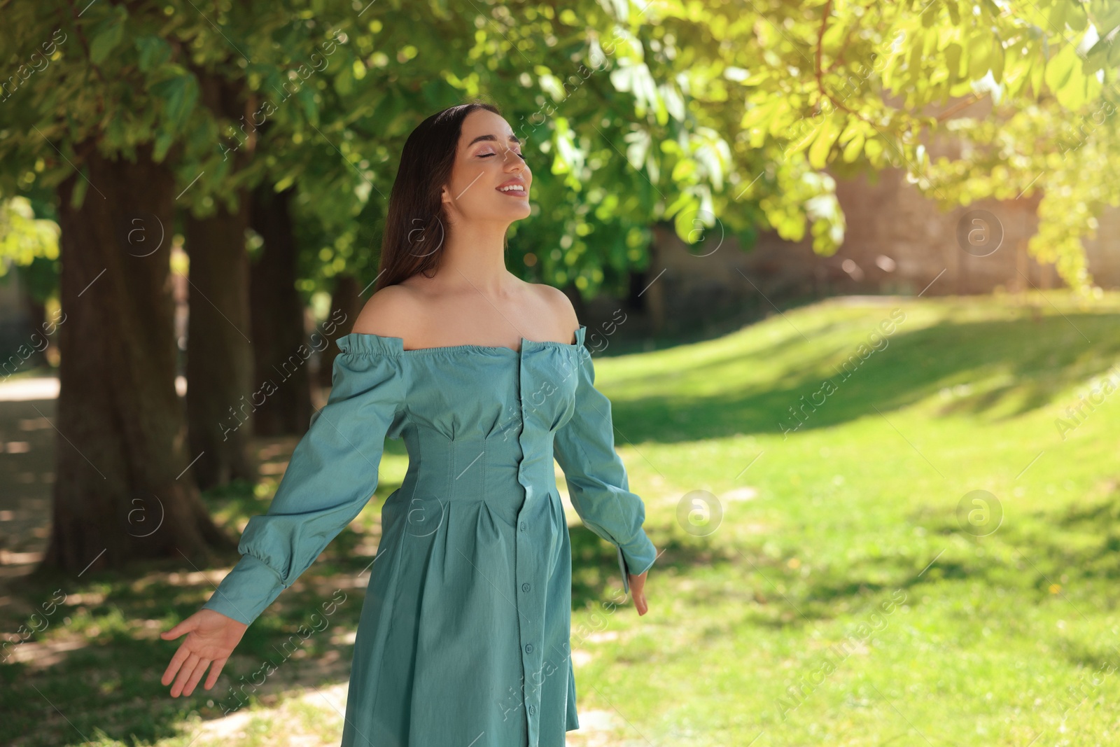 Photo of Beautiful woman in park, space for text. Spring sunny day