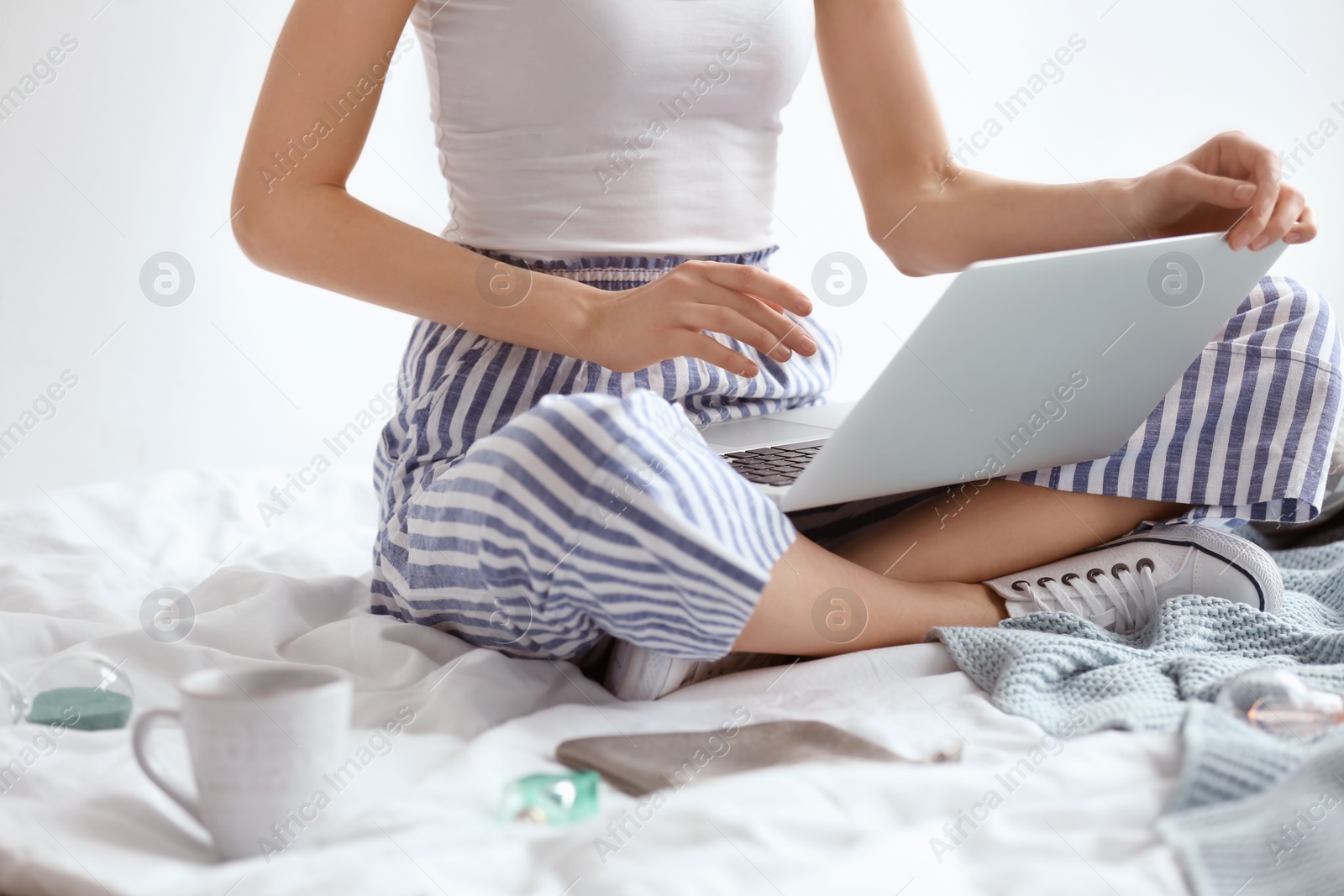 Photo of Female blogger with laptop on bed