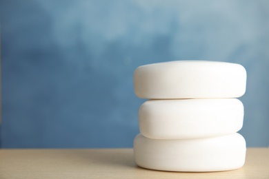 Photo of Stack of soap bars on table. Space for text
