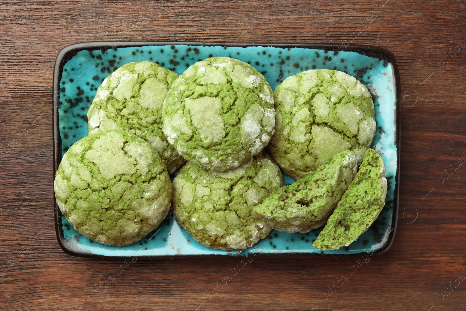 Photo of Plate with tasty matcha cookies on wooden table, top view
