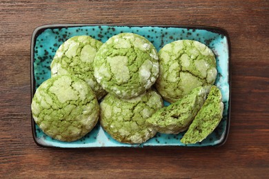 Photo of Plate with tasty matcha cookies on wooden table, top view