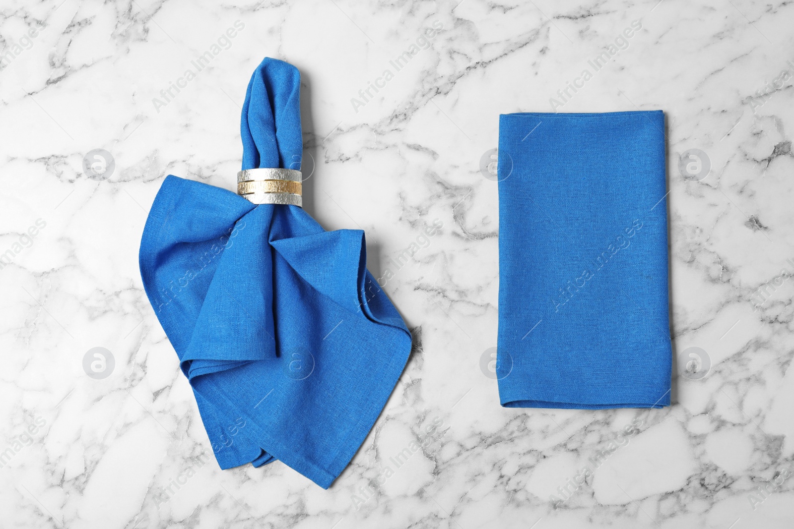 Photo of Fabric napkins for table setting on marble background, top view