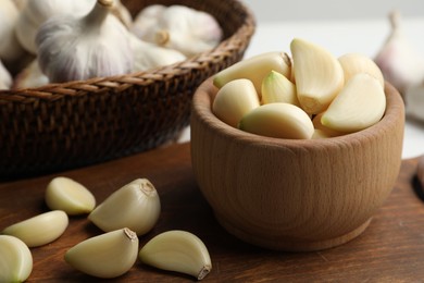 Photo of Fresh organic garlic on wooden board, closeup