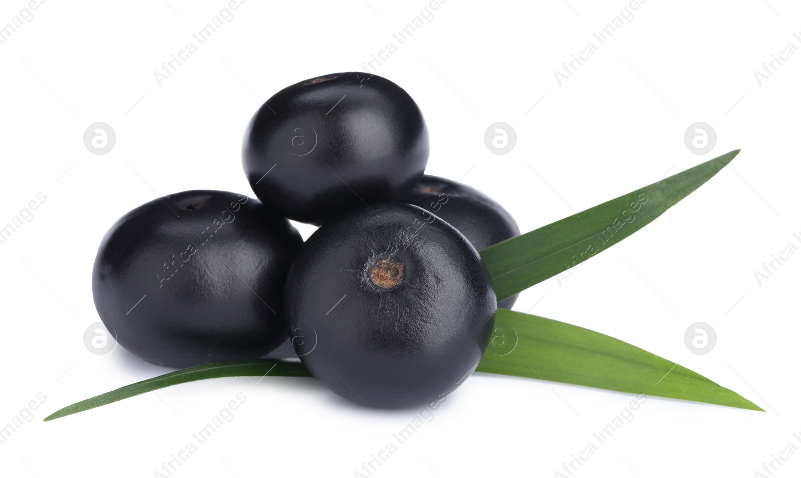 Photo of Pile of fresh ripe acai berries and green leaves on white background