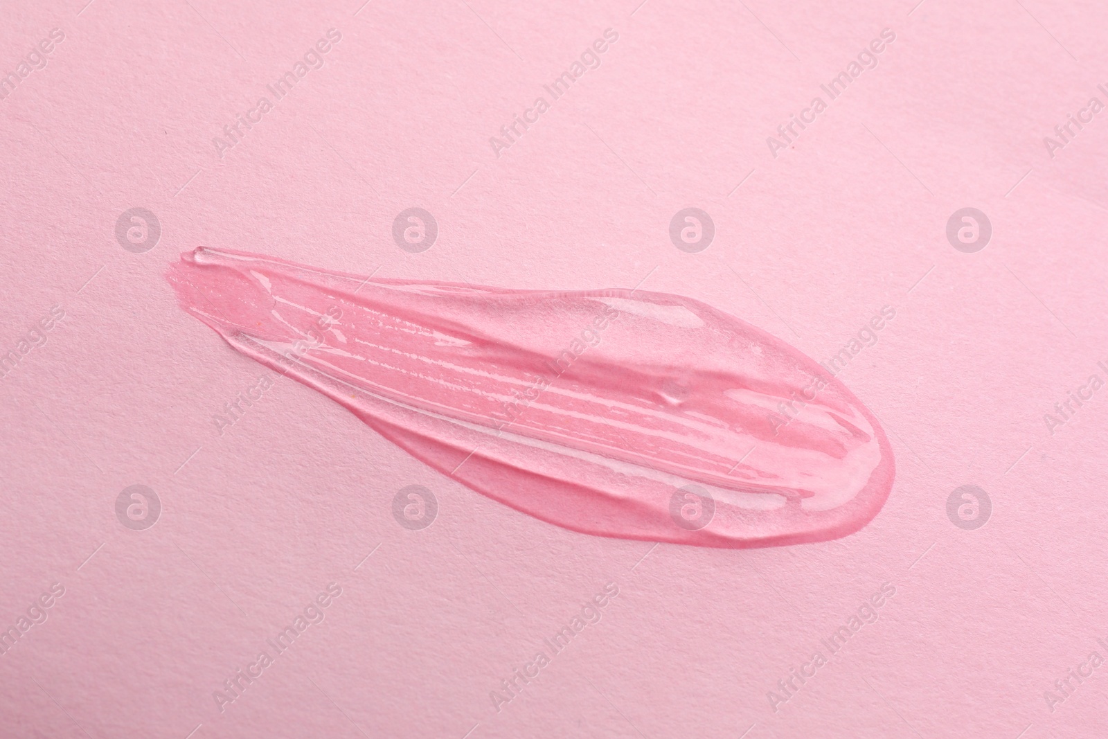 Photo of Sample of transparent gel on pink background, top view