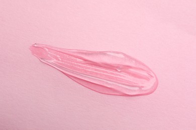 Photo of Sample of transparent gel on pink background, top view