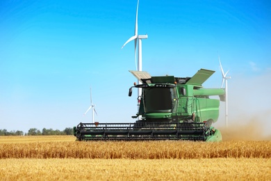 Modern combine harvester working in agricultural field