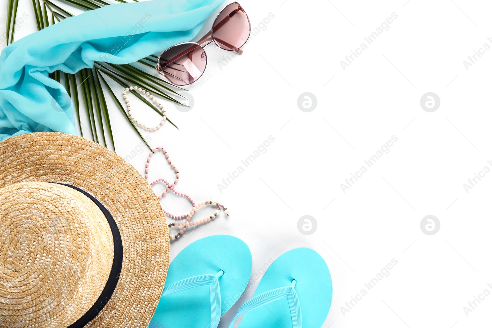 Photo of Flat lay composition with stylish hat and beach objects on white background