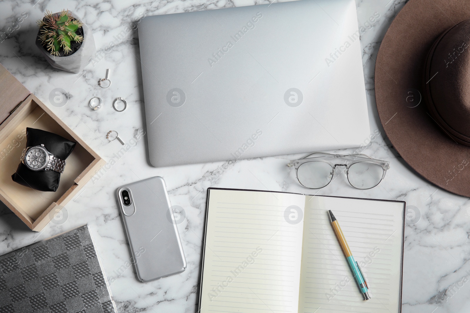 Photo of Flat lay composition with laptop and blank notebook on marble table, space for text. Blogger's workplace