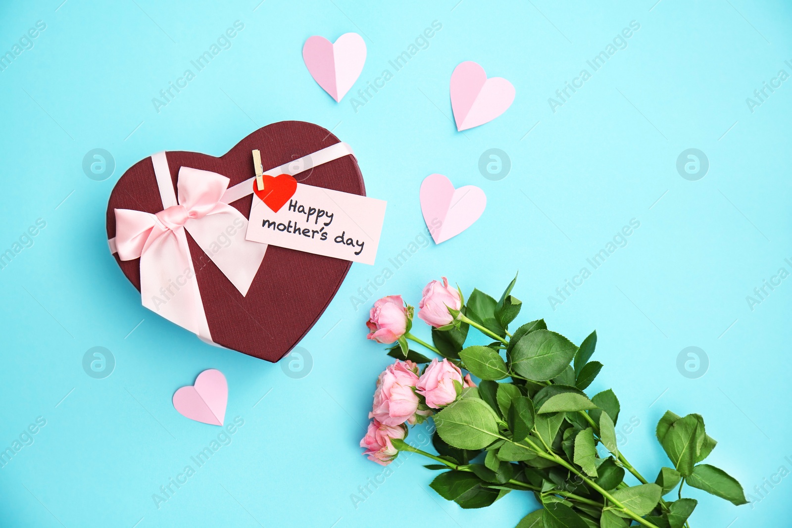 Photo of Gift box, roses and greeting card with text "HAPPY MOTHER'S DAY" on color background