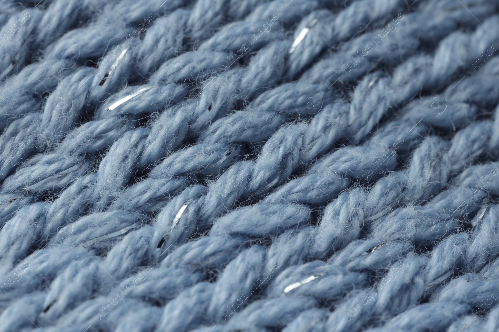 Photo of Light blue knitted fabric as background, macro