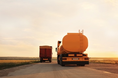 Modern bright trucks parked on country road