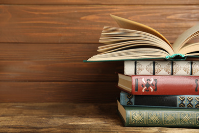 Photo of Collection of old books on wooden shelf, space for text