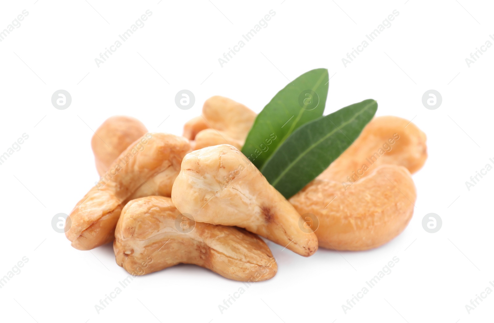 Photo of Pile of tasty organic cashew nuts and green leaves isolated on white