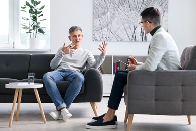 Professional psychotherapist working with patient in office